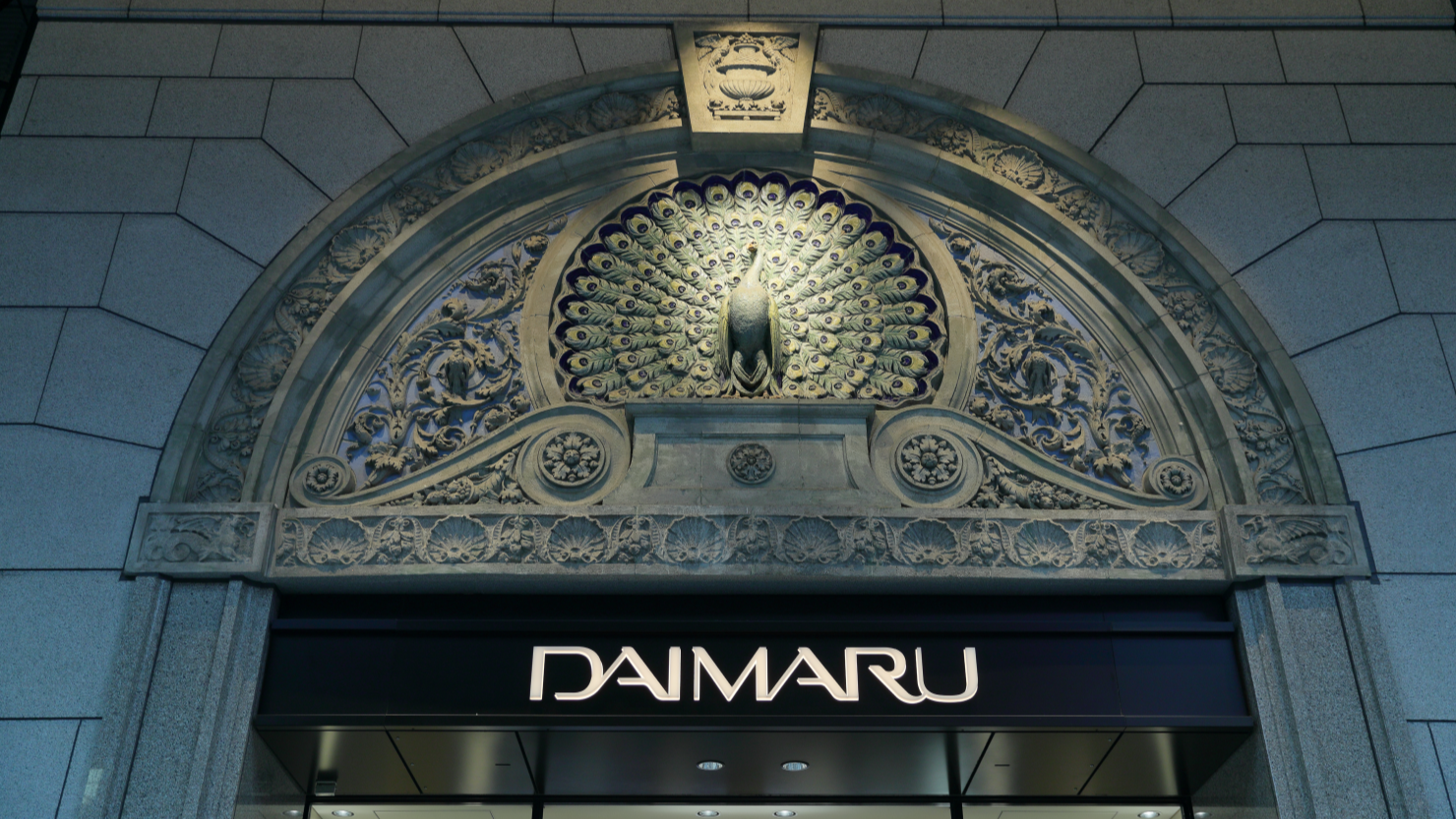 心斎橋のアーケードに面したかつての中央玄関には、1925年の2期工事で取り付けられた孔雀の装飾が残る