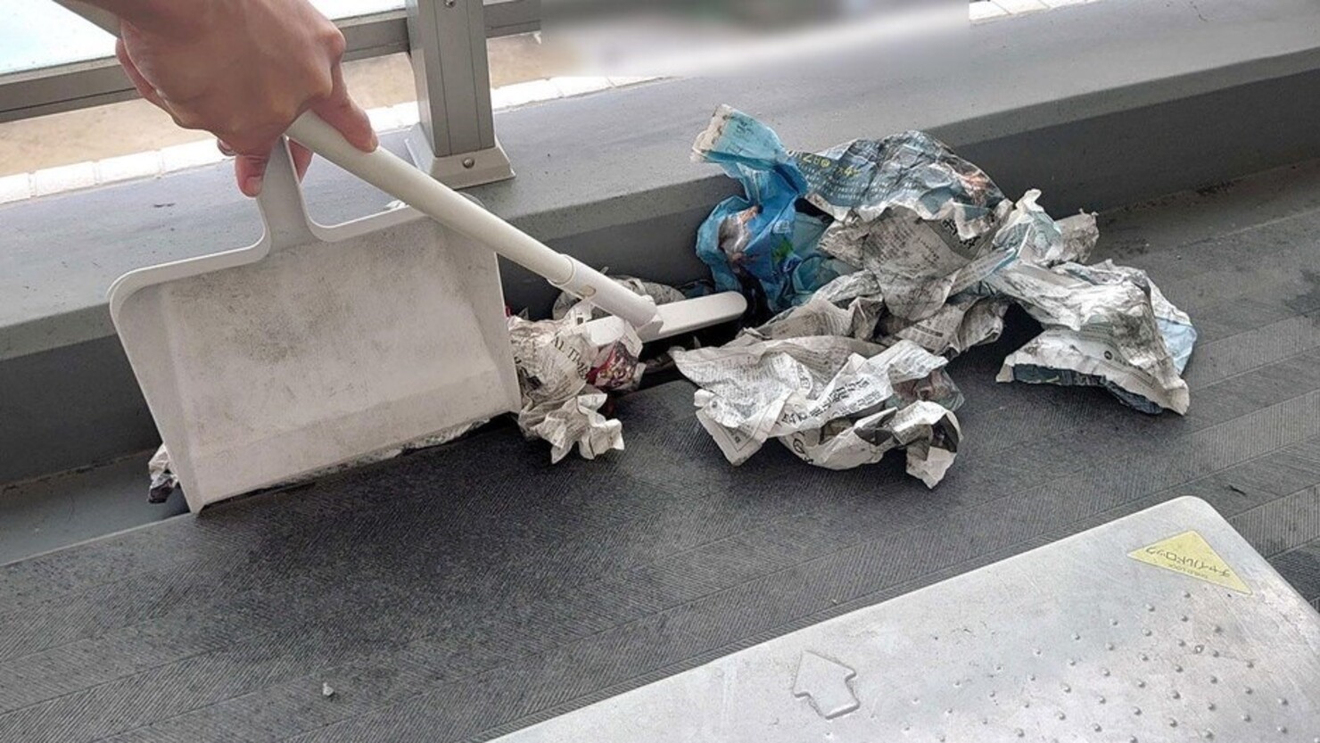 ちりとりも使ってグイグイ拭きとる　© 橋尾