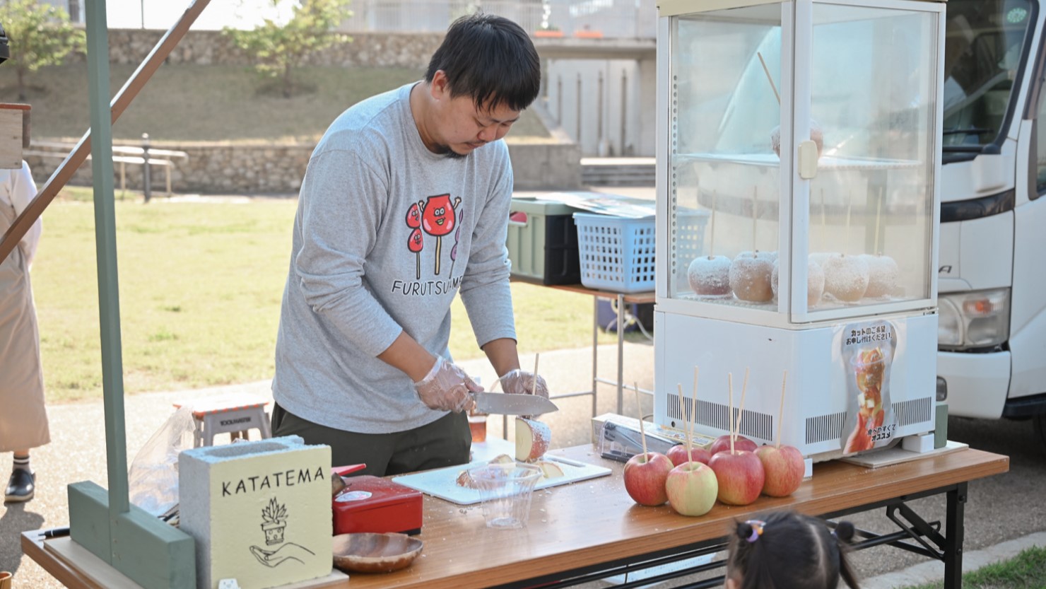 手作りのりんご飴を販売する出店者