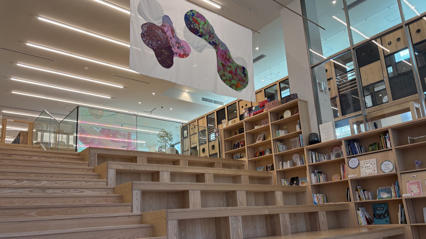 coしぶやの館内の様子。入り口を抜けると大きな階段が目に飛び込み、自由に絵本を読むことができる。木の温もりが感じられホッと落ち着く空間     