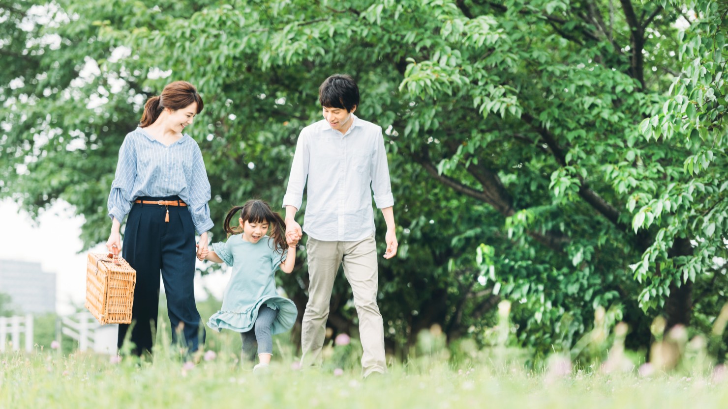 手をつないで歩く家族