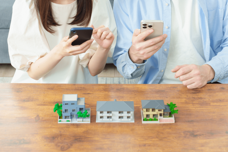 スマホで移住計画する男女の手元