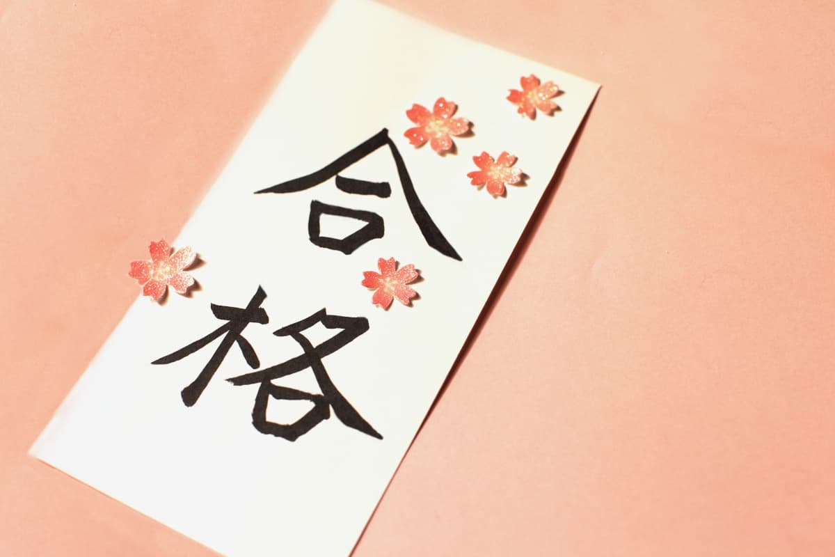 縦長の髪に書かれた合格の文字