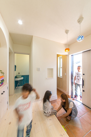 玄関ホールのアーチ型の飾り棚は、西洋漆喰の風合いがやさしく雰囲気に