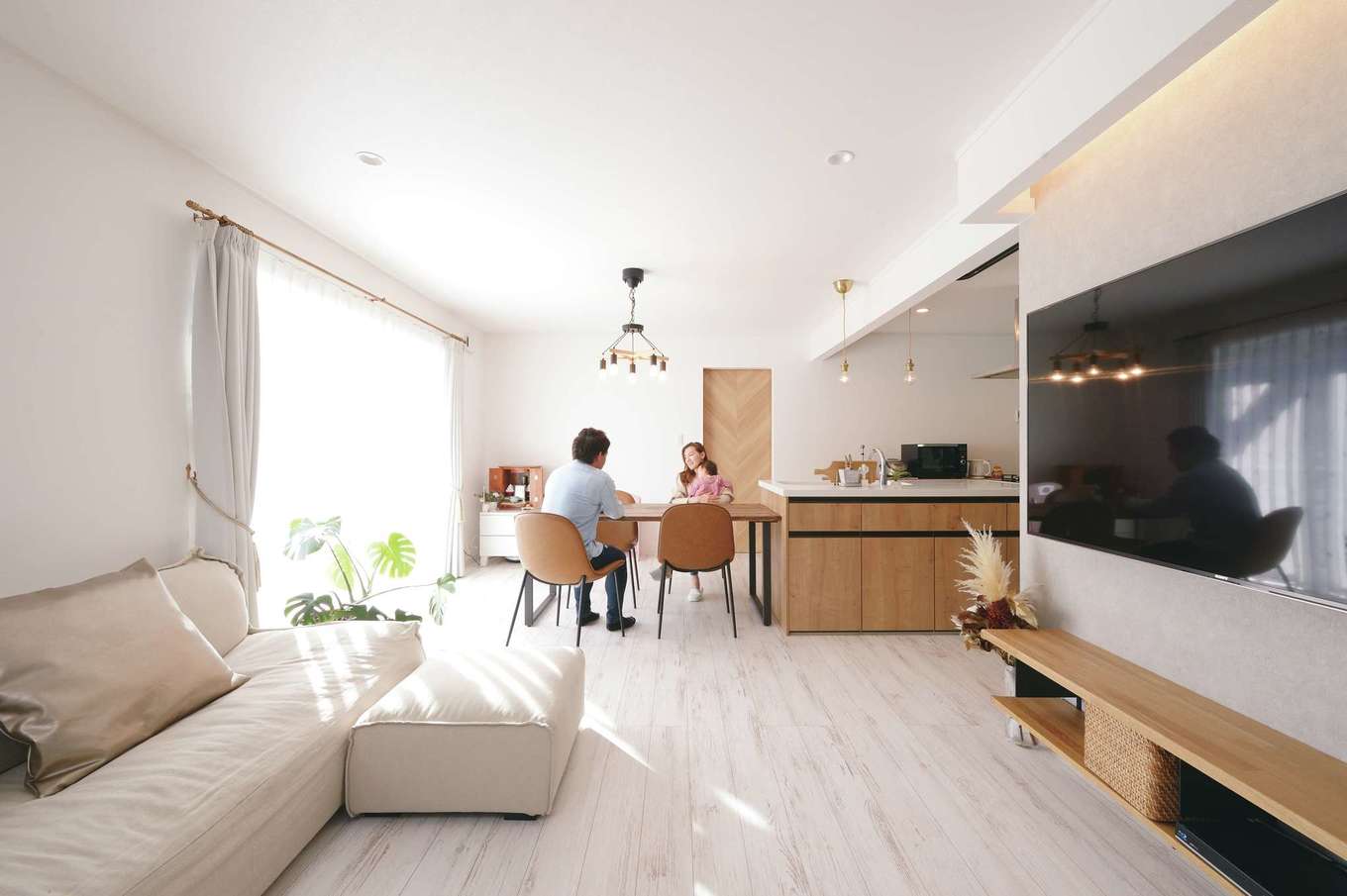 ハートホーム【子育て、輸入住宅、間取り】2×4工法ならではの間仕切りのない大空間。ダイニングテーブルをキッチンの真横に配置したことで、奥さまの家事効率もグーンとアップした。気密性が高いので、交通量が激しい表通りの音も気にならない