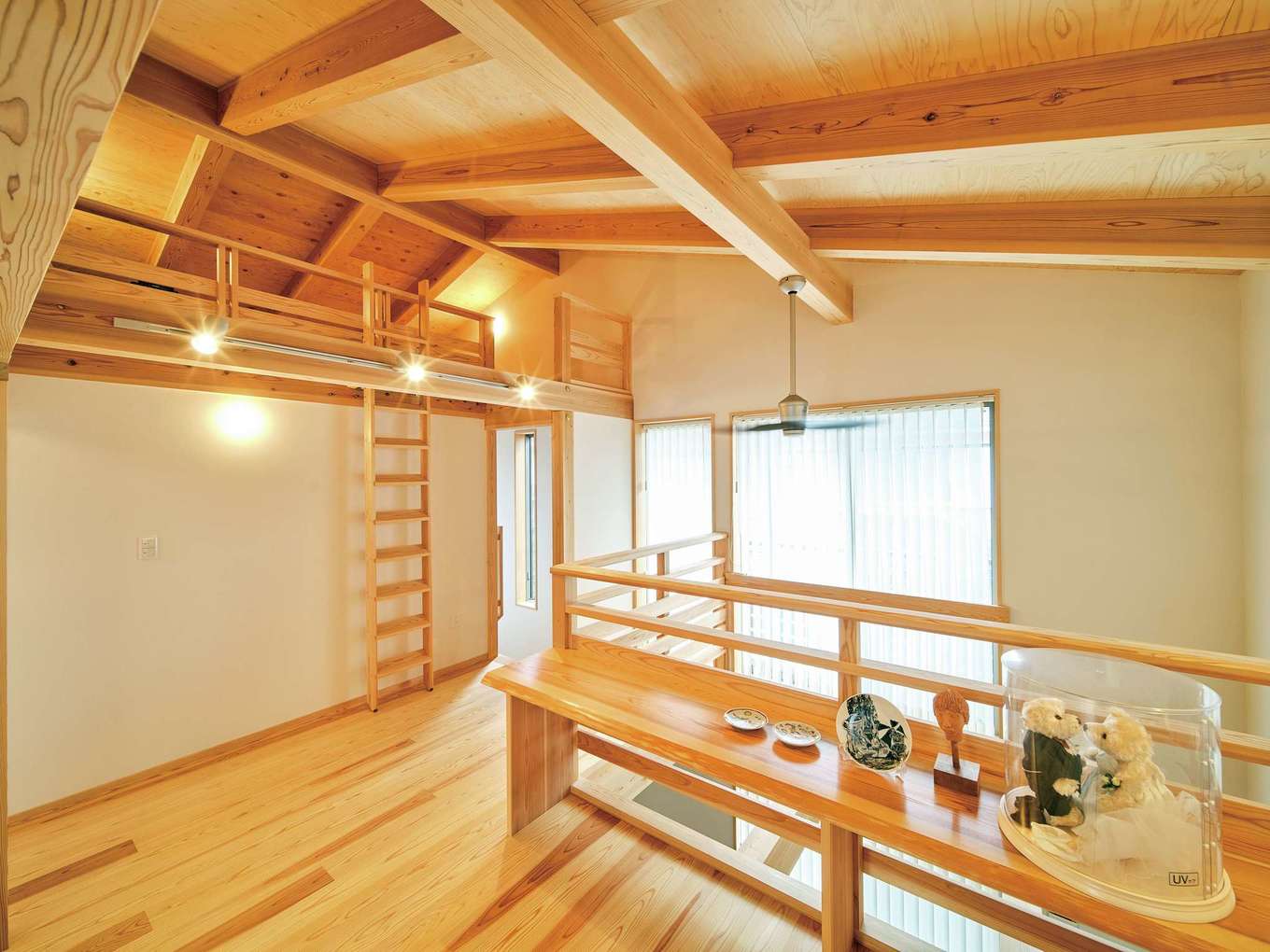 アクトホーム【自然素材、省エネ、間取り】2階にも無垢が敷かれ、目にも心地いい。勾配天井による大らかさに包まれるホールは多様な役割を果たす。書斎カウンターがつながりを生み、用途に自由度をもつ空間が暮らし方の変化を受け止める