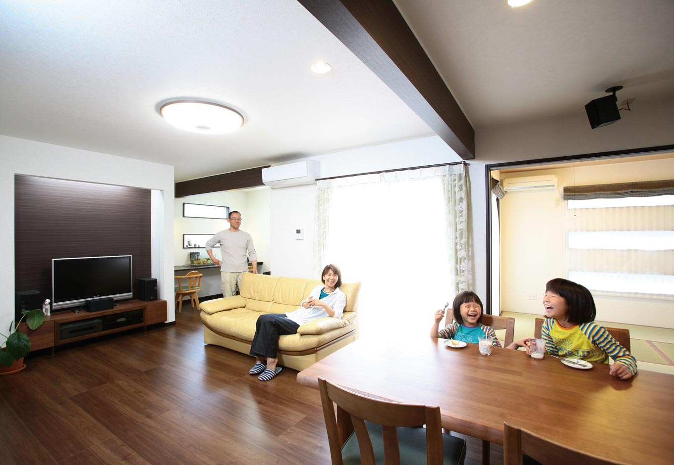 アフターホーム【1000万円台、デザイン住宅、狭小住宅】子どもたちの勉強スペース、テ レビコーナー、ウッドデッキ、和室、 ダイニングと、用途ごとの空間が 連なった広々としたリビングダイニ ング