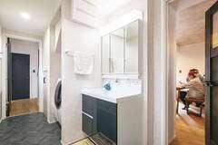 玄関からリビング、ランドリールーム、洗面脱衣室、浴室、そしてキッチンへと回遊できる動線。子どもが泥んこで帰ってきても、リビングが汚れる心配がなく、奥さまも大助かり