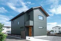 庭の使い方も考慮し、建物を計画。「いかにも“家”というフォルムが好き」という奥さまが希望した三角屋根とガルバのモスグリーンによって、シャープさとあたたかみのバランスのよい外観に