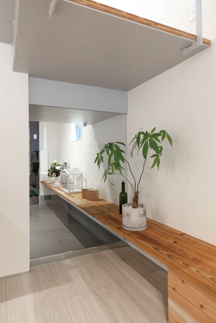 建杜 KENT（大栄工業）【デザイン住宅、収納力、間取り】リビングや玄関の視覚的な広がりをもたらし、帰宅した家族の様子も確認できるガラスの壁面。ふたつの空間をつなぐシェルフのデザインも斬新だ