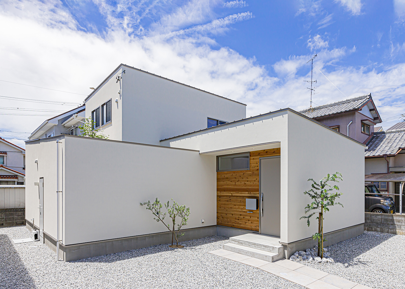 ARRCH アーチ【デザイン住宅、間取り、建築家】斜めの壁や木目のアクセントなど、見た目の印象で他とは少し異なる雰囲気を表現した外観。壁で庭を囲むスタイルは少しシンプルになりがちなので、下屋になる箇所の屋根ラインと壁上端ラインを繋ぎ合わせ、ボリューム感やインパクトを創出した