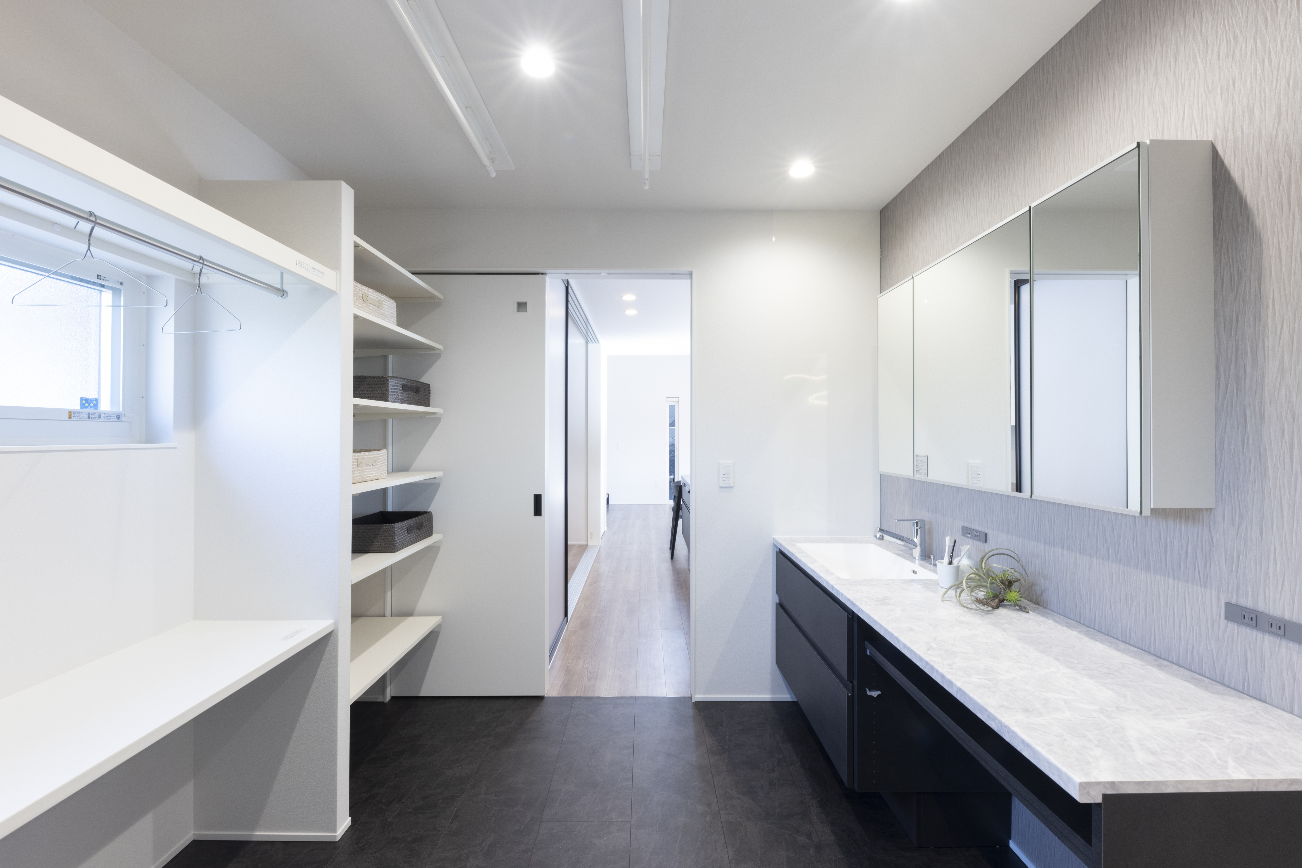 フェスティナ・レンテ｜シンプルでモダンな洗面スペース。広々としたカウンターと十分な収納棚が備えられており、機能性とデザイン性を兼ね備えている。