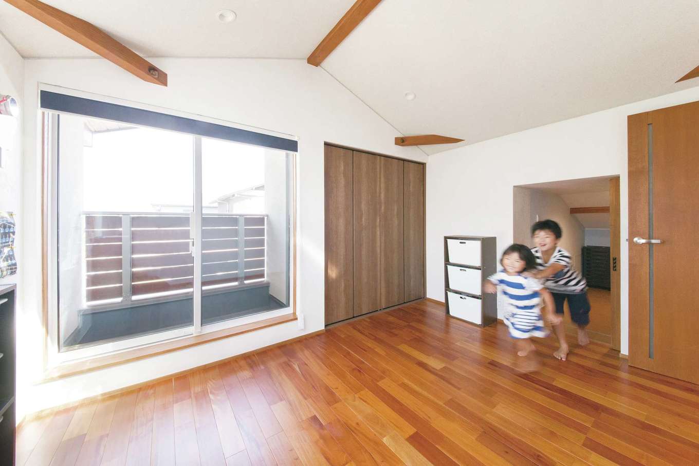 神谷綜合建設 カミヤの家【デザイン住宅、子育て、和風】子ども室の本棚をスライドさせると奥には秘密の小部屋が。収納スペースとしても活躍。夫婦の寝室は1階に配置し、子どもが独立した後は1階だけで生活が成り立つように設計した