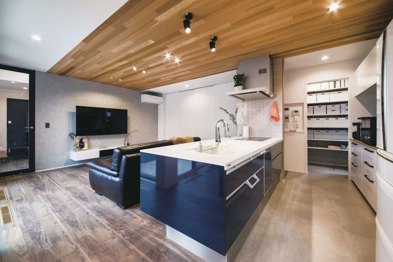 コットンハウス【デザイン住宅、省エネ、間取り】アイランドキッチンは、家族の暮らしの中心。行き止まりのない動線を確保し、さらにパントリーもスペースをたっぷり確保した。キッチンに立つと室内全体を見渡せる