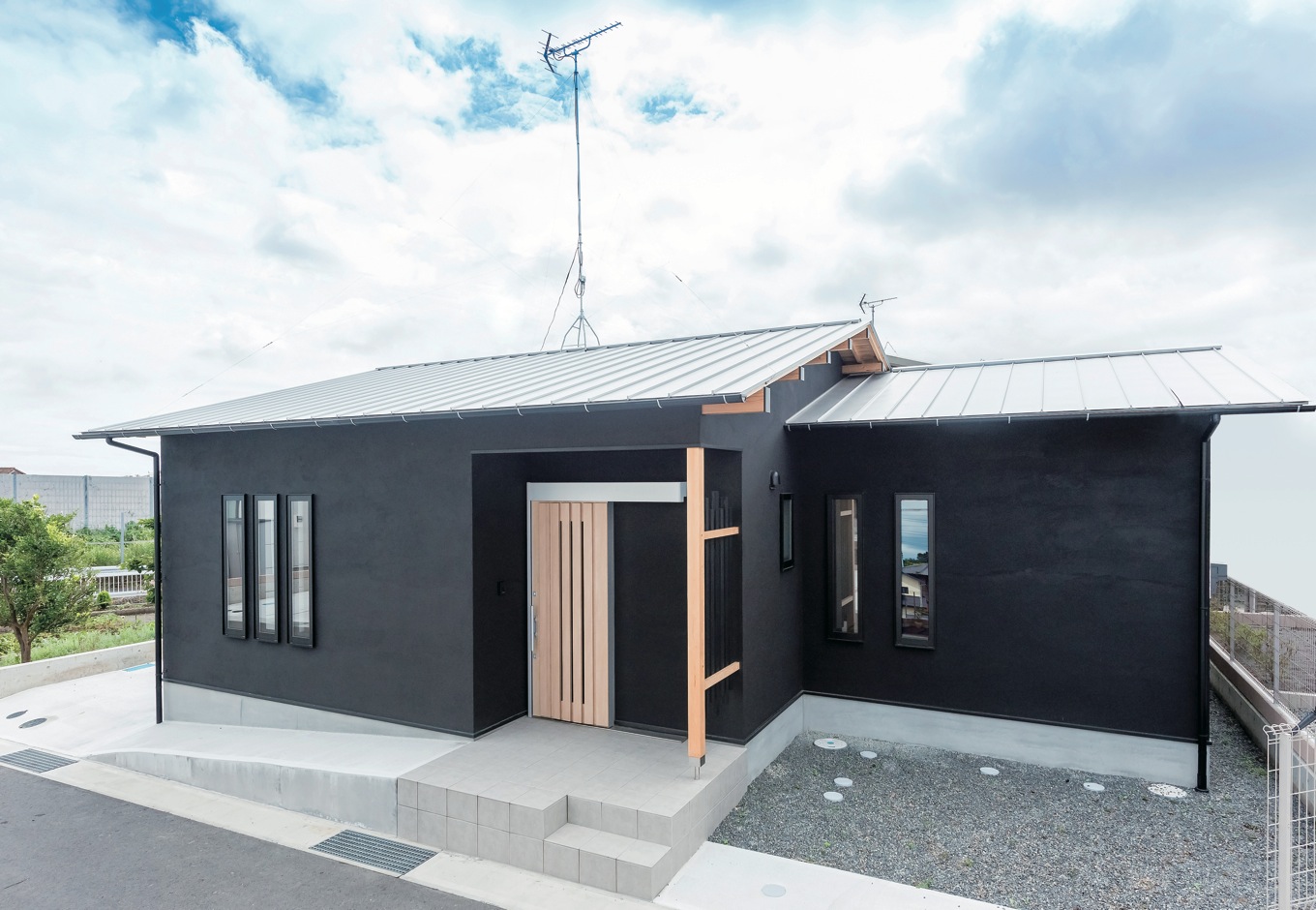 ハウテックス【1000万円台、自然素材、平屋】重厚感のある黒い塗り壁の外観。駐車スペースは3台分確保。ポーチへ続くスロープが将来の安心を約束