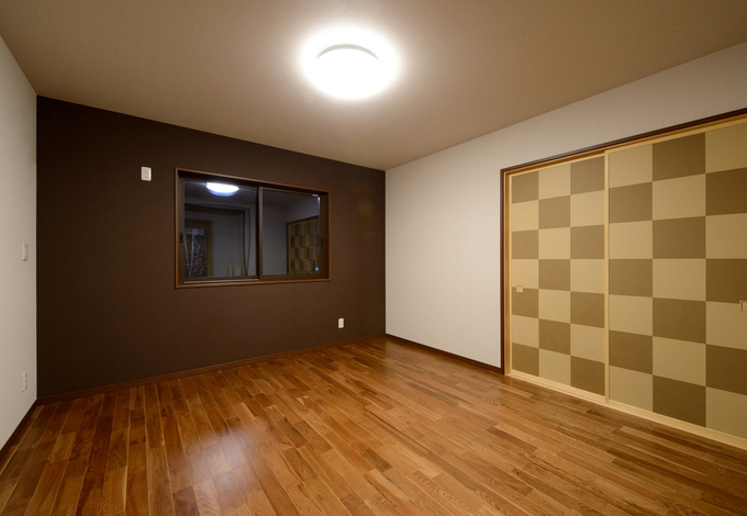 子世帯の寝室。明るいリビングとは対照的に、やすらぎの雰囲気でコーディネート。クロスの落ち着いた色づかいにセンスが光る。クローゼットも大きく確保し、抜群の収納量を誇る