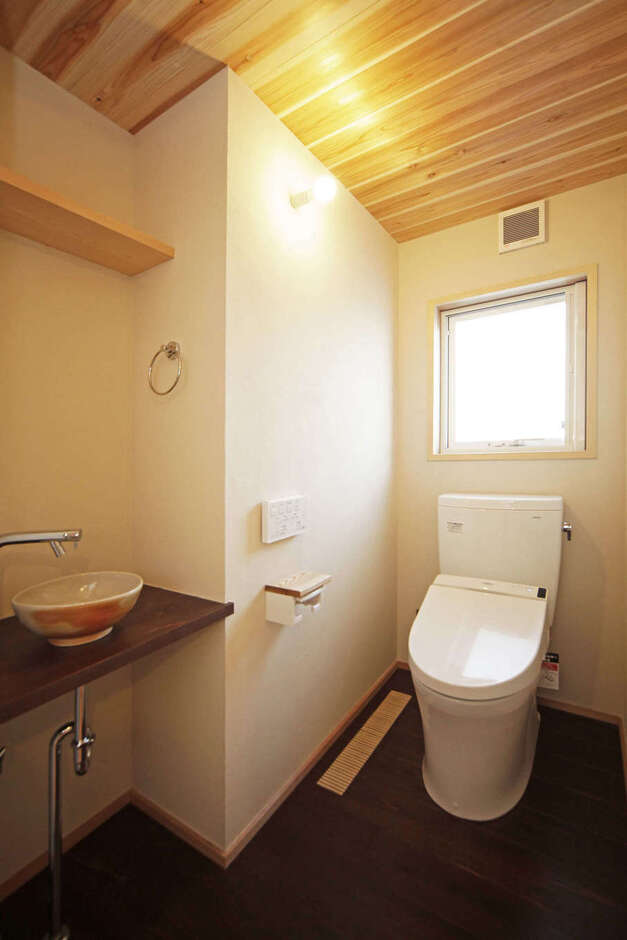 トイレの床は、杉の板に漆を塗って防水性を高めている。手洗い鉢は、地元遠州の陶芸作家のもの
