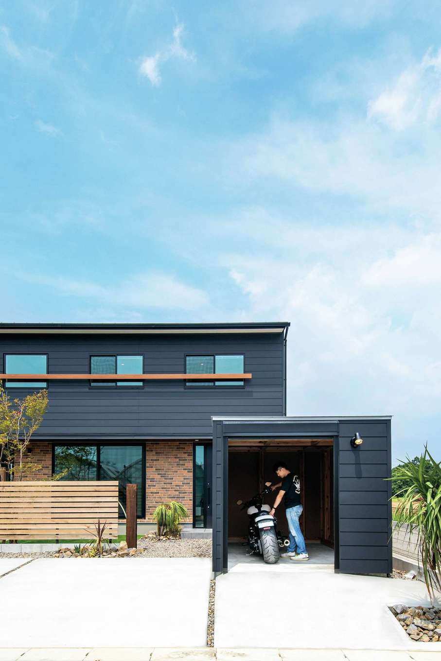 住たくeco工房【趣味、間取り、ガレージ】「木箱house」の前面にバイクガレージ用の「木箱mini」を設け、統一感のある外観が実現。黒い外壁のアクセントにレンガ調の外壁を組み合わせたのがご主人のこだわり