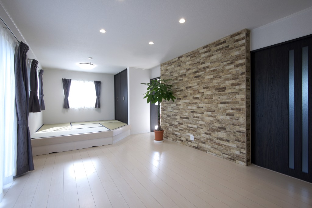 メテックス建築事務所【1000万円台、子育て、省エネ】アクセントウォールがスタイリッシュなリビング。建具の黒と白い壁や床のコントラストも印象的