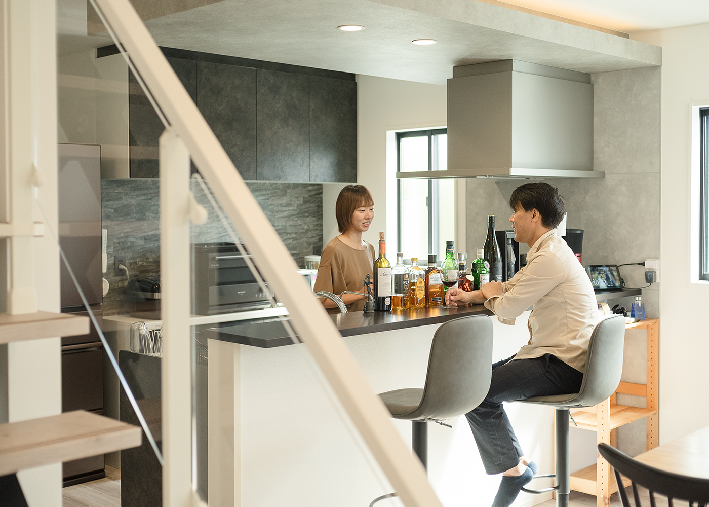 HAPPY HOUSE（山田工務店）【子育て、間取り、屋上バルコニー】ご主人念願のバーカウンターで過ごすひとときは至福の時間。モノトーンでシックにまとめた。左手のパントリーはサイズも使い勝手も大満足