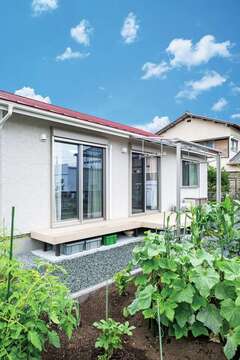 軒を出した掃き出し窓はちょっとした雨でも開けておけて換気ができる。庭では、家庭菜園で野菜を育てている