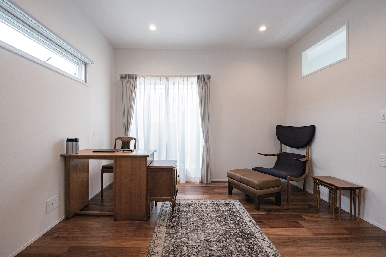 OWN RESORT HOME（オウンリゾートホーム）【1000万円台、デザイン住宅、インテリア】シンプルな空間に存在感のあるヨーロッパのデスクとチェア、チェストを合わせた仕事部屋。隣家との距離が近い左右の窓は視線を避けて高めに付けた