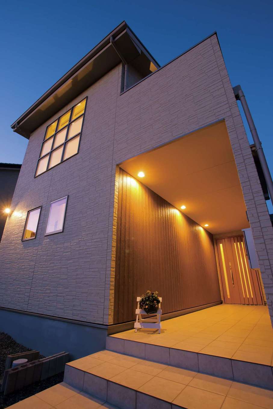住宅工房 アリアンス【子育て、省エネ、間取り】屋根付きの長いポーチは雨に濡れないので便利。玄関までの距離がこれだけあると、仕事モードから家庭モードへと気持ちのリセットも容易にできそう