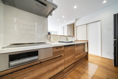 ウッド調でナチュラルな印象のキッチン。広々とした調理スペースがあり、料理をゆったり楽しめる空間。