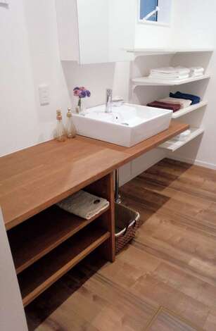 広めのカウンターは、身支度に忙しい時間に便利なスペース。造作のオープンシェルフが使いやすい