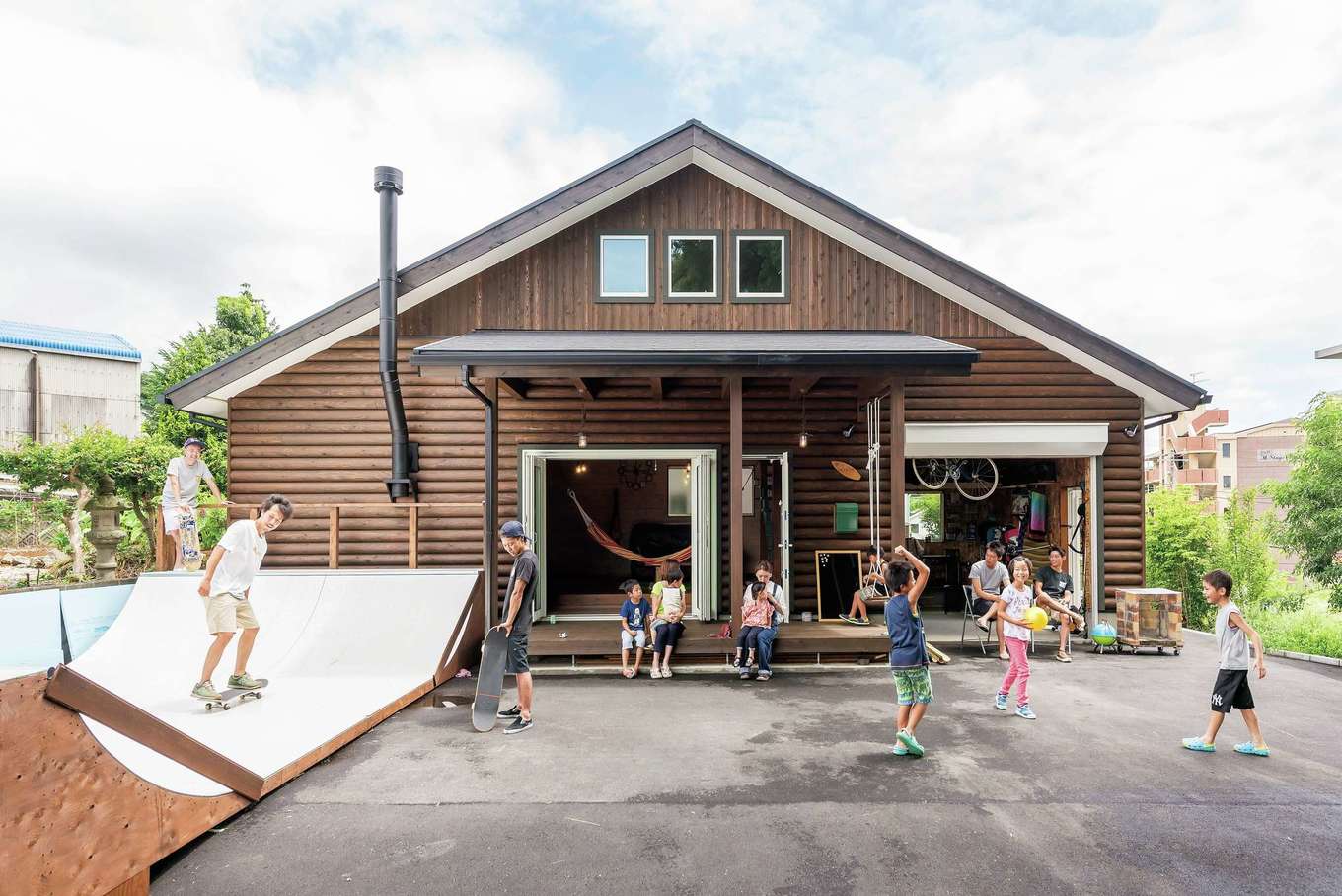 イーホーム【趣味、自然素材、ガレージ】山奥にあるログハウスをイメージした大屋根の外観。普段は中央の大開口窓から出入りする。右手がガレージ。自宅にスケボーランプを作りたいという壮大な夢が実現した