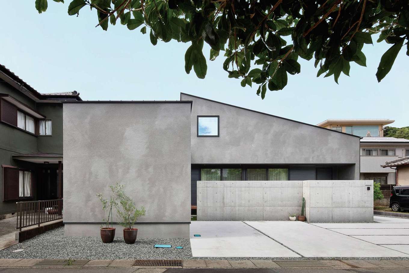 ハウスプラン（R＋house沼津・富士）【デザイン住宅、省エネ、間取り】一見すると平屋のようなT邸。リビングには大きな掃き出し窓を設けたが、深い軒と庭を囲むように設置したコンクリートウォールのおかげで、室内のプライバシーも守られている