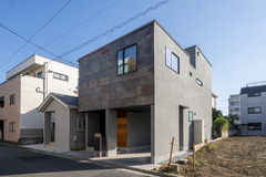 モダンなデザインの住宅の外観。シンプルなラインと落ち着いた色合いが調和し、都市型ライフスタイルに適した佇まいである。
