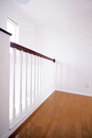 2階ホールは、玄関の吹き抜けとつながっており、小柱の間から光が抜けて美しさが際立つ