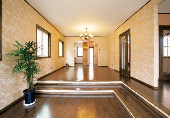 段差を活かしたリビングはホームパーティーも可能な30畳。キッチンの入り口は西欧風アーチを採用