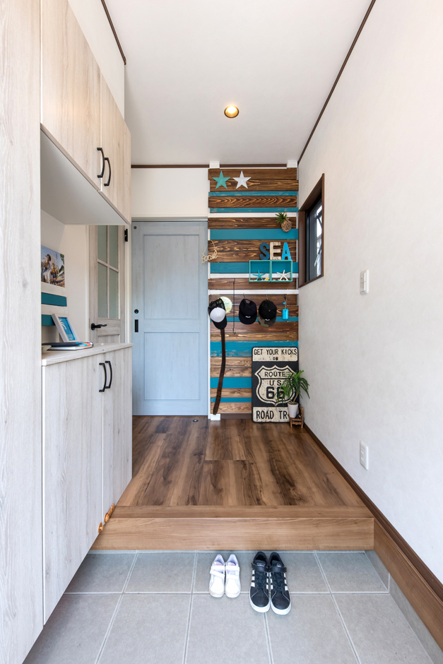 東海ハウス【1000万円台、屋上バルコニー、間取り】玄関も白×木で統一。正面のウォールボードは家族の手作り