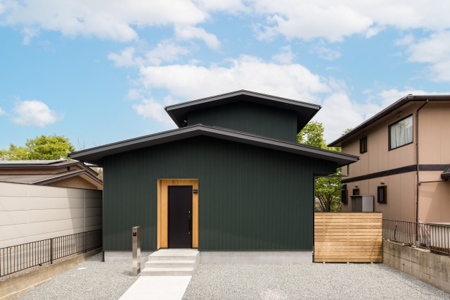 KEN建築工房｜シンプルでモダンな外観の平屋建て。均整の取れたフォルムとダークカラーが洗練された雰囲気を演出しています。左右対称の構造が印象的である。