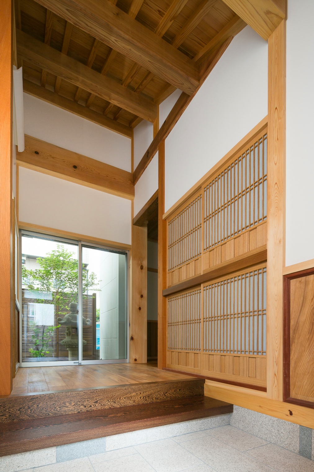 櫻 工務店【和風、自然素材、高級住宅】玄関ホール。天井が高く坪庭の緑がよく見えるのも魅力的である。