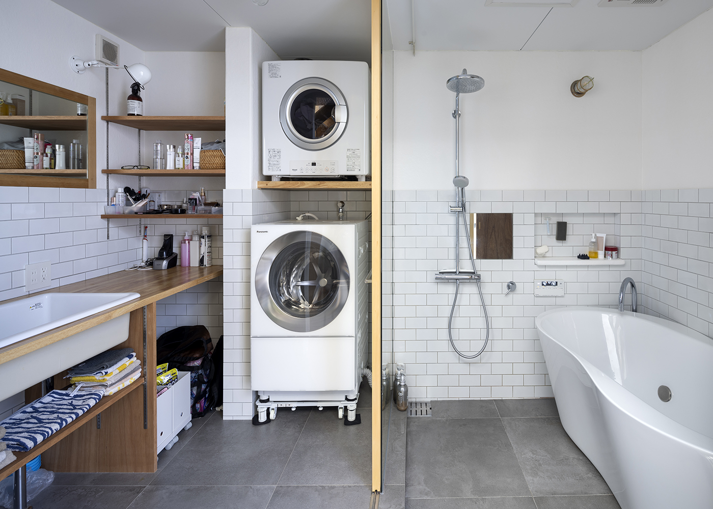 NATUREスペース【狭小住宅、建築家、スキップフロア】脱衣所を兼ねた洗面とランドリースペース。壁のタイルや床材をお風呂と一緒にし、空間につながりをもたせた