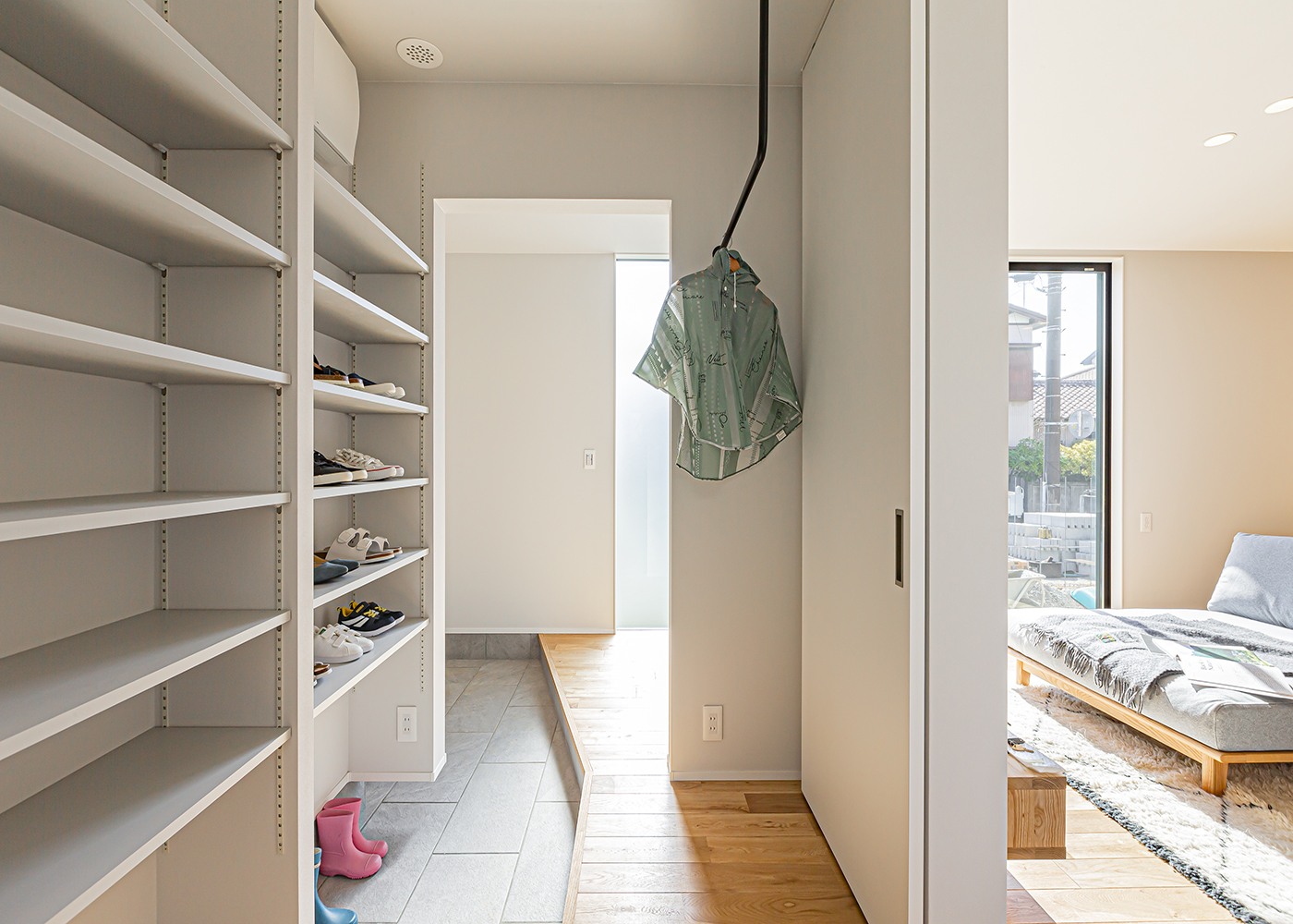 ARRCH アーチ【デザイン住宅、間取り、建築家】玄関には2WAYの動線を確保。家族が帰宅すると、靴のままシューズインクローゼットを経由して洗面やランドリーへ向かうことができる