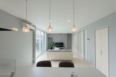 開放感あふれるLDK。照明が洒落たムードを演出し、白を基調としたインテリアが明るい雰囲気を引き立てている。