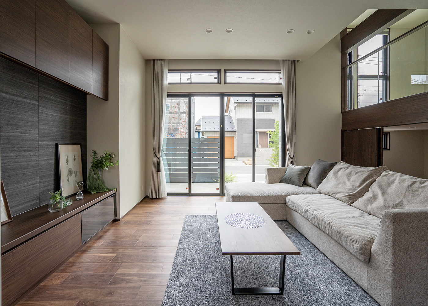 ミサワホーム甲信【デザイン住宅、収納力、間取り】TVボード背面は、高級感のあるグレーの石調内壁材でコーディネート。スキップルームと高窓から光が差し込む