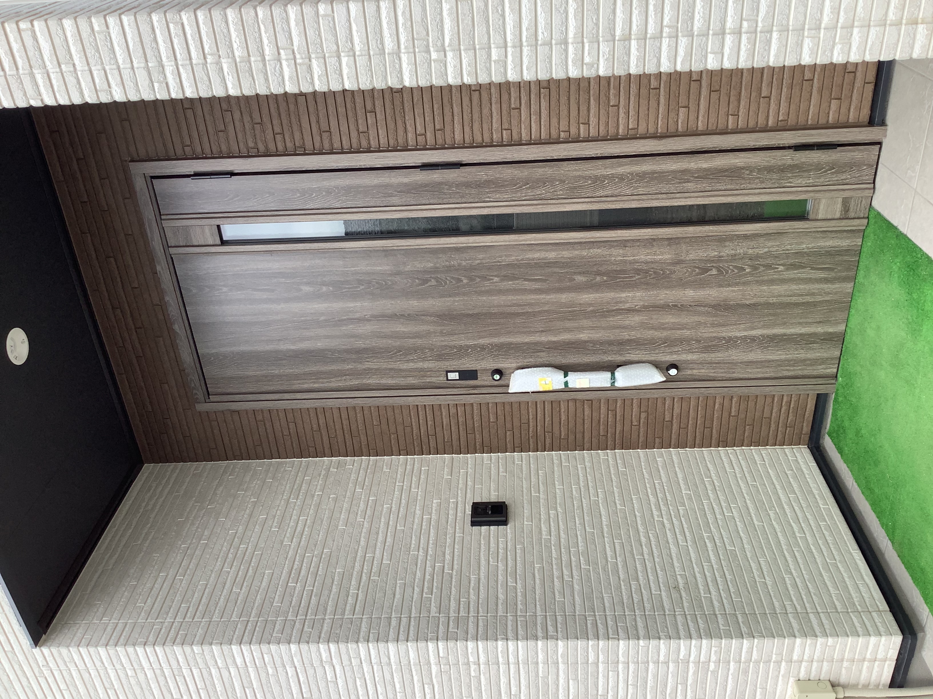 フロート・ハウス｜シンプルでモダンなデザインの玄関ドア。直線的なラインが特徴的で、落ち着いた雰囲気を醸し出している。