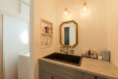 洗面台は市販のキッチンをカスタマイズしたオリジナル。理想のイメージをとことん追求してこだわった、奥さまのお気に入りだ