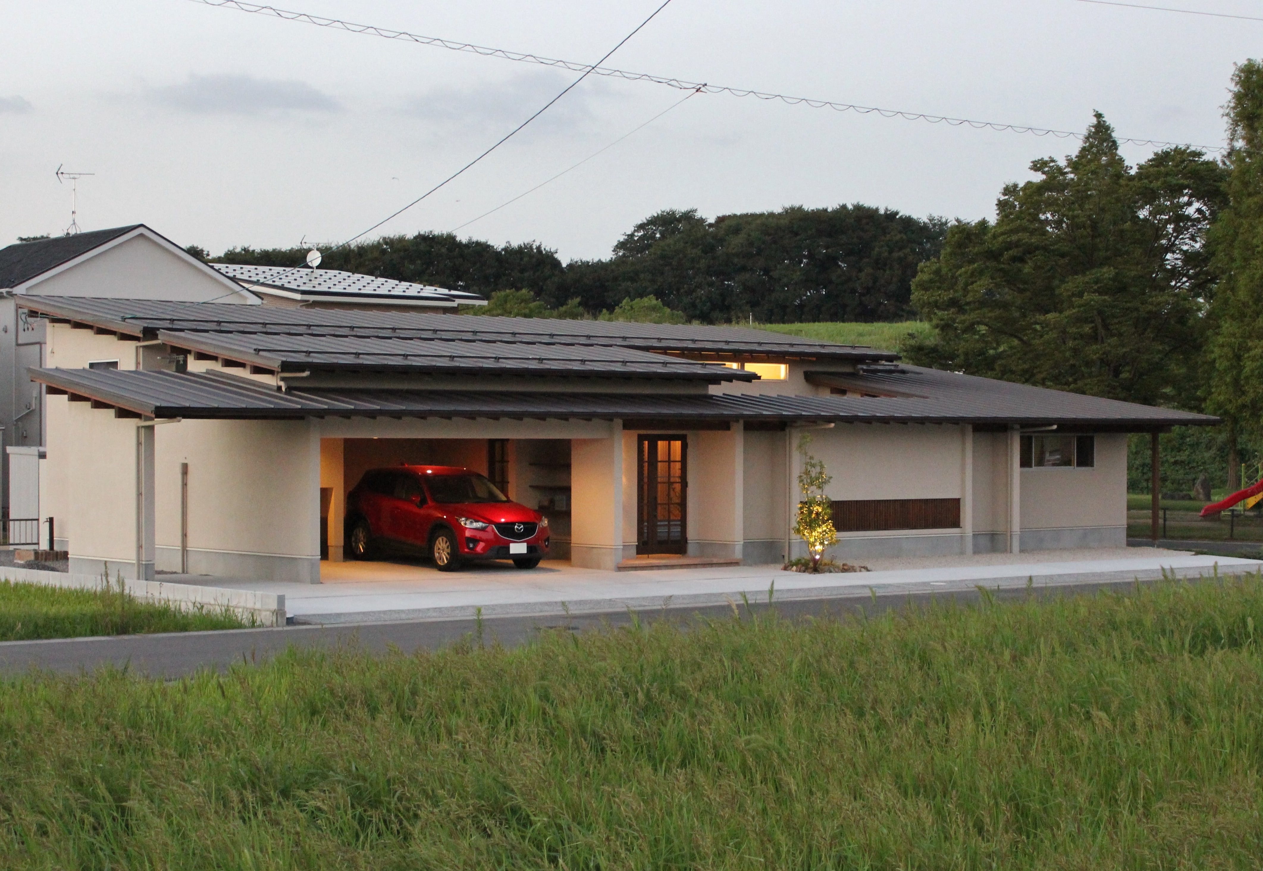 安田住宅｜安田建築設計室｜広々とした屋根付きガレージを備えた住宅。車を雨風から守りつつ、外観はモダンで美しいデザインとなっている。