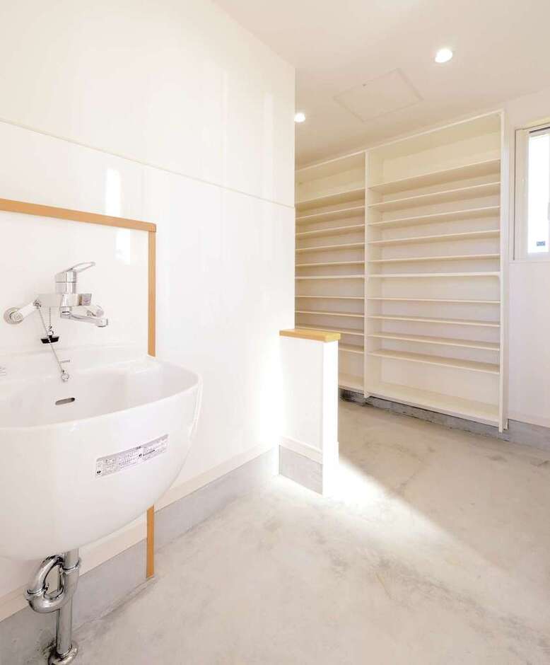 こちらが玄関に繋がる土間収納。水栓を備え付けたのは、ゴルフ好きなご主人が、道具の手入れをするためだ