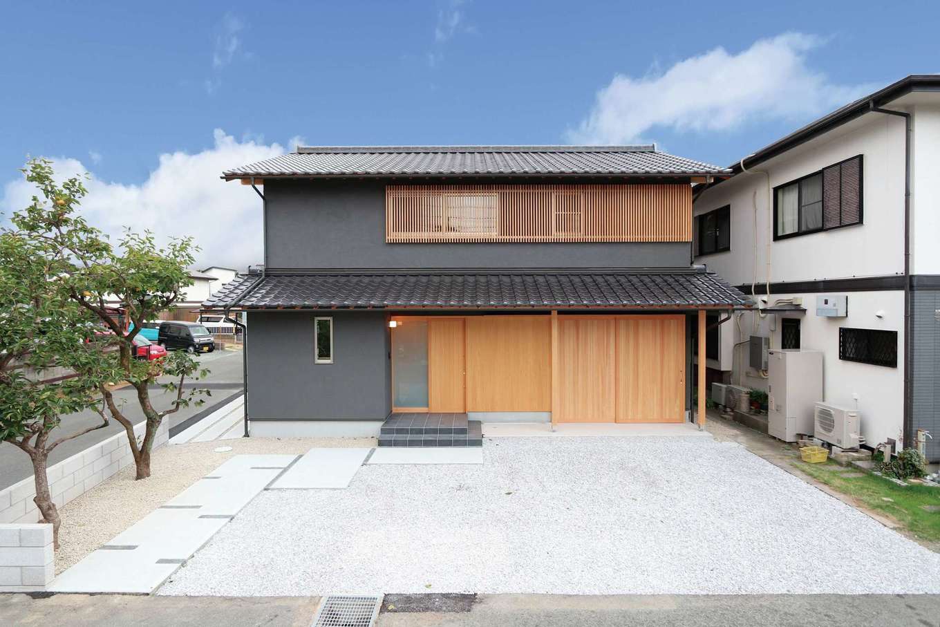 神谷綜合建設 カミヤの家【デザイン住宅、和風、間取り】小ぶりな陶器和瓦を敷き、黒色の塗り壁に木格子やガレージの引き戸が映える町屋風の外観。少しだけ家の高さを抑えることで、正面からの美しさを演出