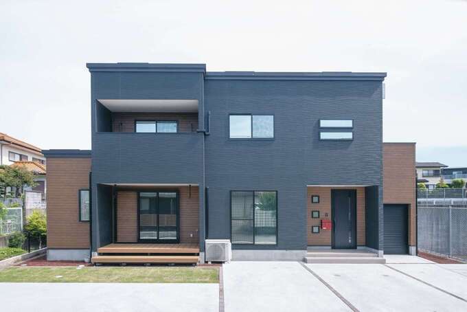 ワイドスパンに建物を設計したことで、実面積よりも大きく見える外観。ブラックのスクエアなフォルムがおしゃれ。右側は水路、左側はスロープ、裏には広い公園が広がり、子育てするには絶好のロケーション