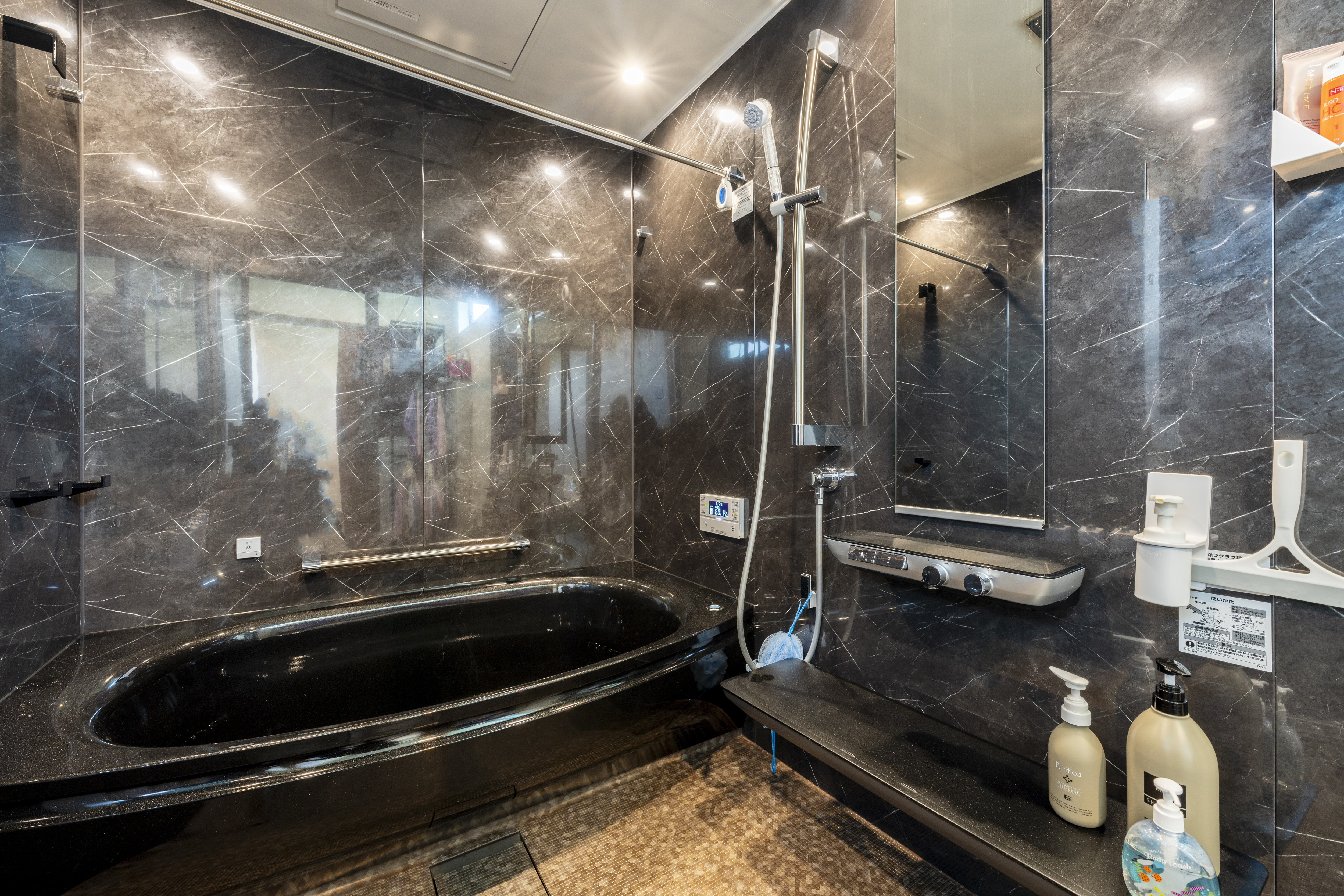 広島建設 セナリオハウス｜高級感ある黒を基調としたスタイリッシュなバスルーム。広々とした浴室空間がリラックスできるひとときを提供しています。