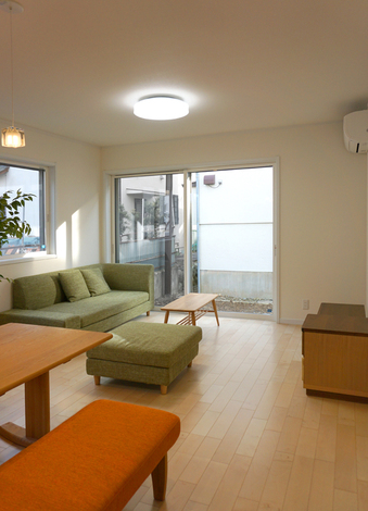 大きな掃出し窓が、明るい陽射しを呼び込むリビング。シャッターを閉めることもできるので、夜間や悪天候時には安心