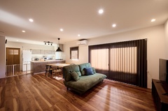 落ち着いた色味のフローリングが美しいLDK。広々とした空間には、シンプルながらもスタイリッシュな家具が配置されている。